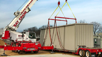 Crane lifting container onto truck