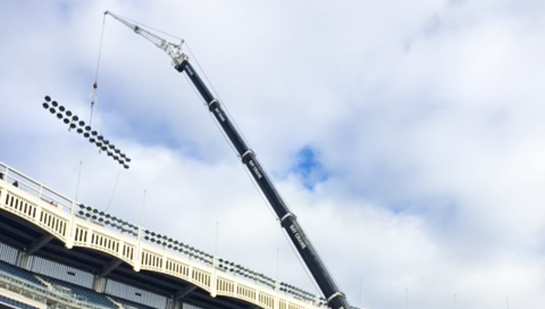 Crane lifting lights in Yankee Stadium