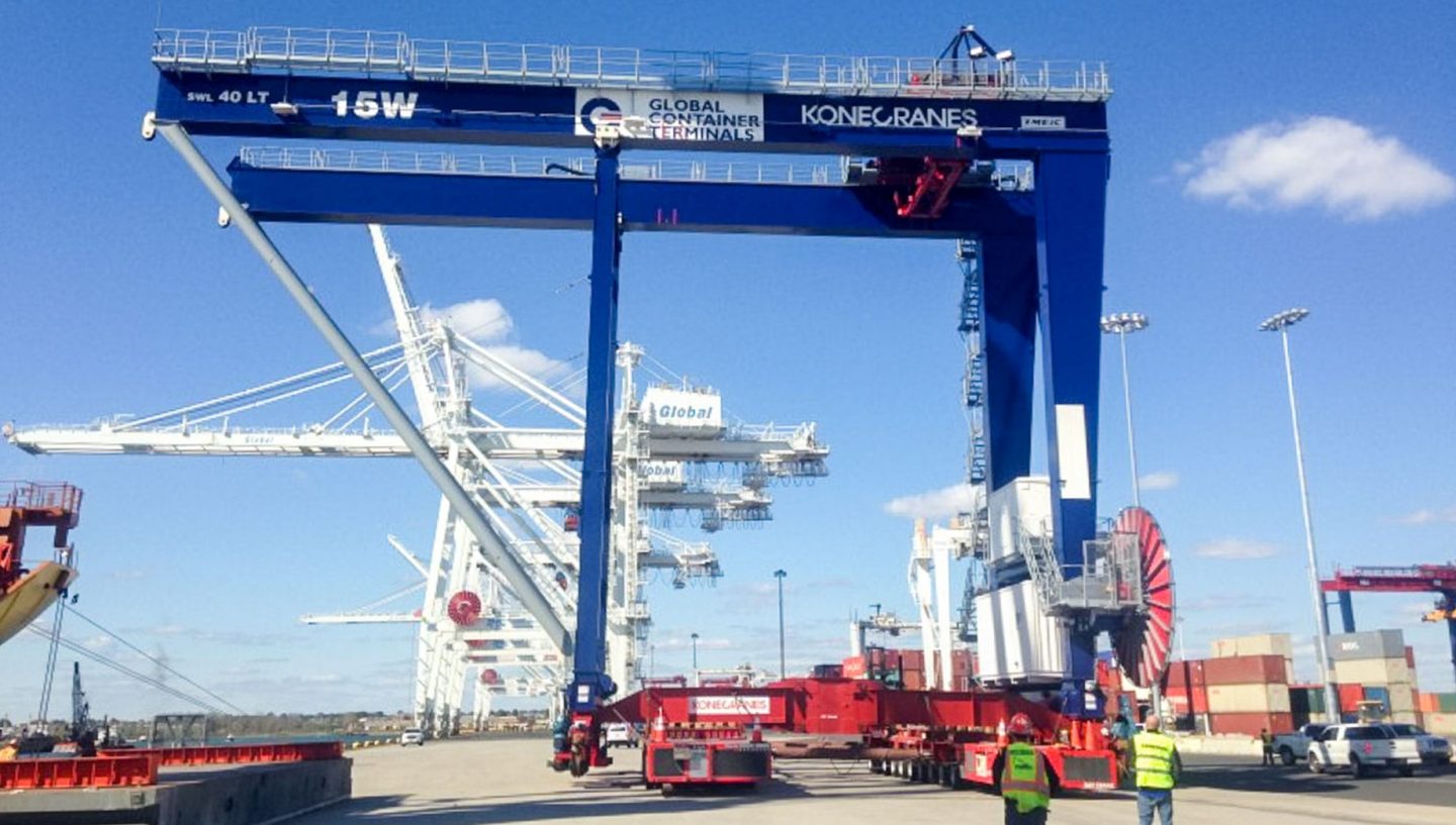 Truck cranes moving harbor cranes into place