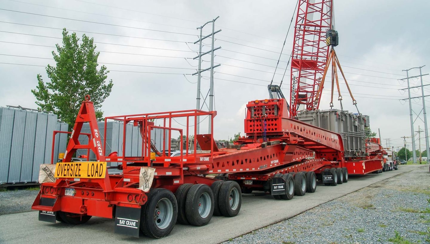 Crane placing equipment on truck