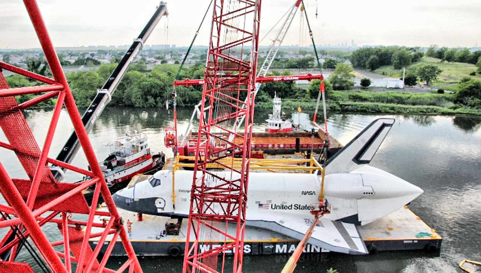 Cranes and space shuttle on river