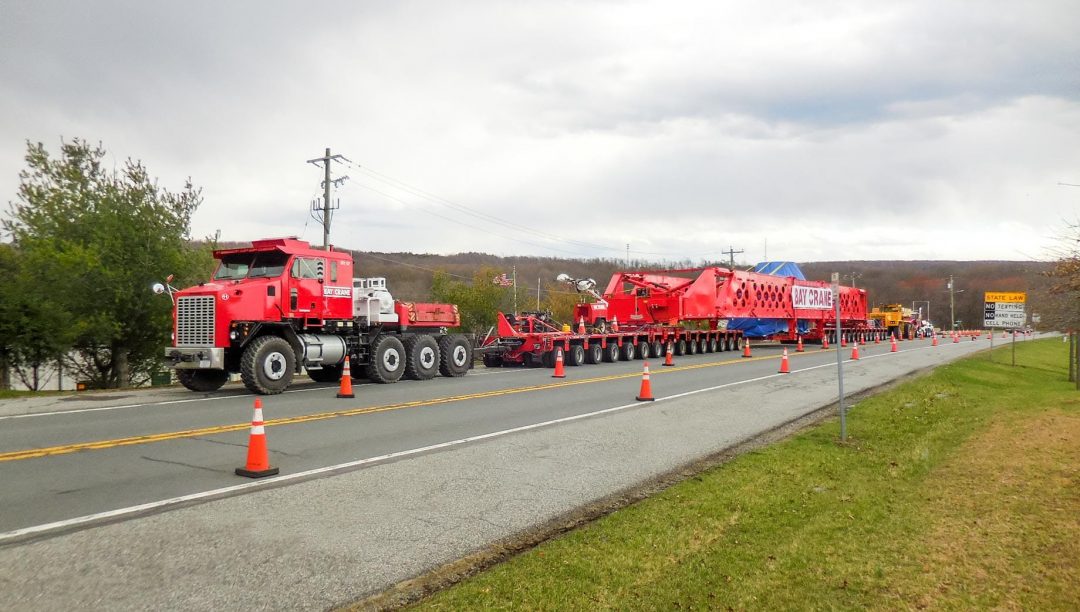 Truck transporting heavy equipment